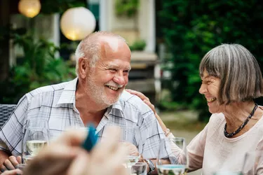 Elderly Couple Smiling At Family BBQ