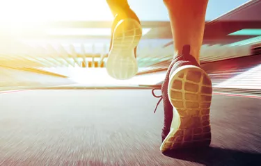 Low Section Of Woman Running On Road