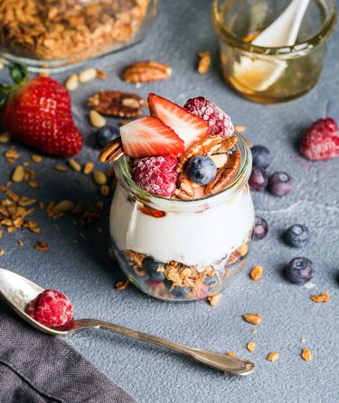 Yogurt oat granola with fresh berries, nuts, honey and mint