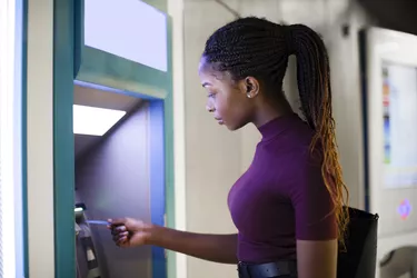 Woman withdrawing money from a cash machine