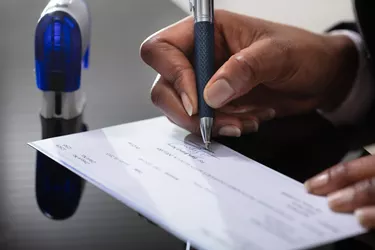 Businessperson Signing Cheque