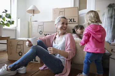 Happy mother and daughters taking a break from moving