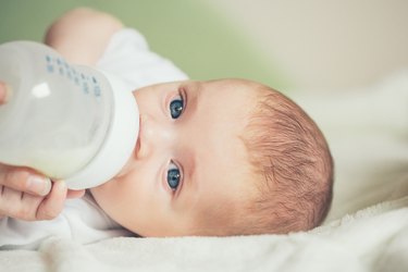 Baby boy drinking milk from a bottle