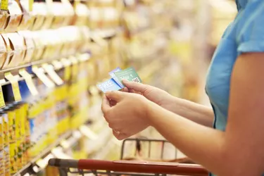 A woman checking her coupons in the store