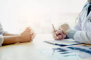 Doctors and patients sit and talk. At the table near the window in the hospital.Doctors and patients sit and talk. At the table near the window in the hospital.