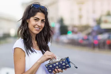 Portrait of beautiful woman with wallet in the hands