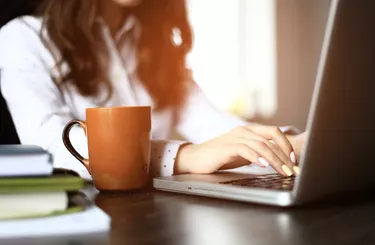 Closeup of a female hands busy typing on a laptop