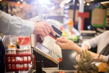 Man Paying with Credit Card in Supermarket