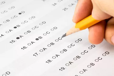 Pencil held over a multiple choice exam
