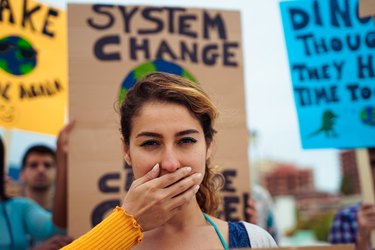 People with signs demanding "climate change" Justice and Climate. Group of demonstrators fight for climate change. Symbol of woman silenced by politics – Image
