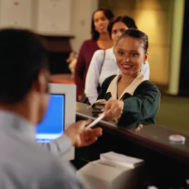 Woman handing check to teller (focus on woman)