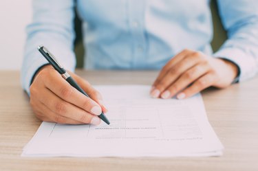 Cropped View of Person Completing Application Form