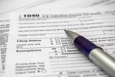How to Meet the IRS Definition of a DependentTax form with pen