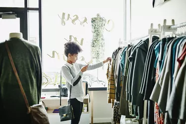 Woman taking photo of clothing with smartphone