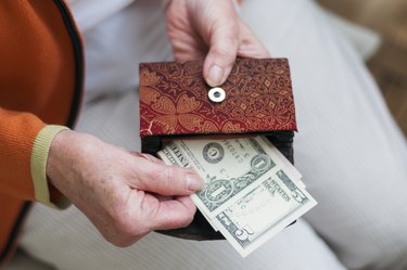 Can a Wife Collect Off Her Husband's Social Security If He Is Still Alive?Senior women looks in her purse