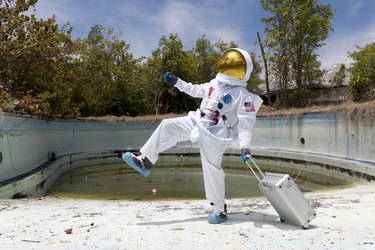 Portrait of an astronaut in empty swimming pool.