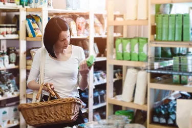 Woman reading product information on label