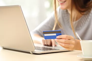 Woman holding credit card.