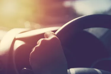 Female hand on steering wheel. Travel and safty concept.