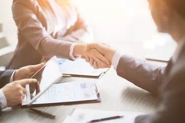 Business people shaking hands, finishing up meeting