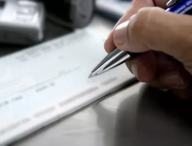 Signing a bank check, business metaphor