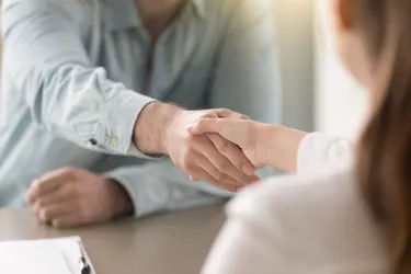 Business agreement handshake of man and woman at the office