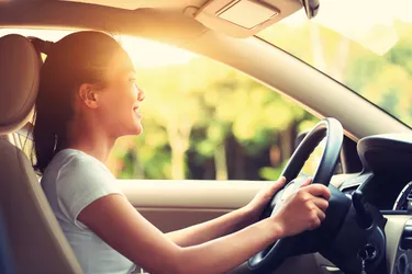 young asian woman driver driving a car