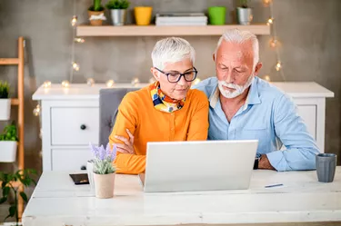 Mature grey senior couple shopping online during pandemic Covid-19 . Corona virus.