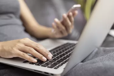 Working woman is working with a smart phone and computer. The concept of women working with technology.