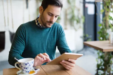 Portrait of young attractive man using tablet