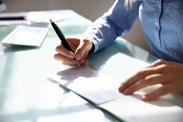 Businesswoman Signing Cheque