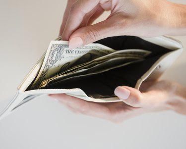 USA, New Jersey, Jersey City, Close-up view of pulling one dollar note from wallet