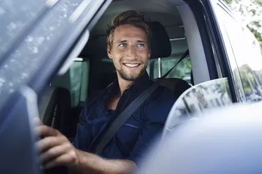 Smiling young man in car