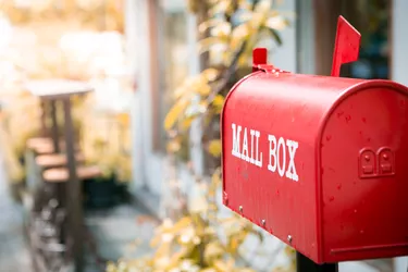 Red mailbox in front of the house with sunlight and beautiful natural background