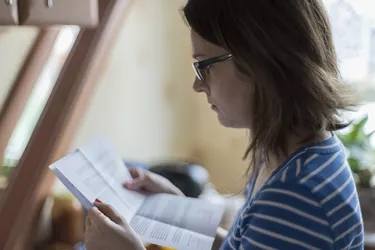 What Is an Apartment Rental Offer Letter?Young woman reading official letter