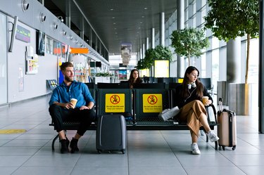Passengers waiting for flight in airport terminal