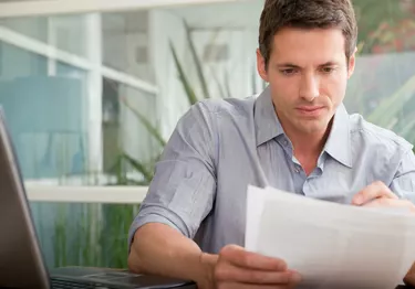 Adult man looking over papers
