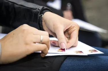 Woman glueing a stamp to letter