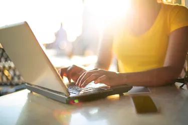 Girl working with her laptop in a bar