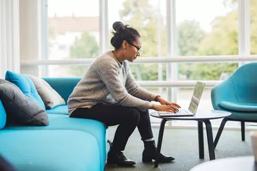 Woman using laptop in living room