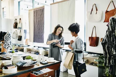 Owner processing credit card with digital tablet