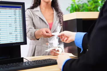 Bank Teller Working with Customer at Bank Counter in Retail Bank