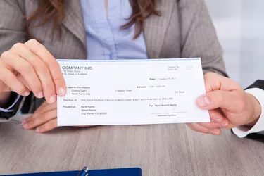 Businesspeople Holding Cheque