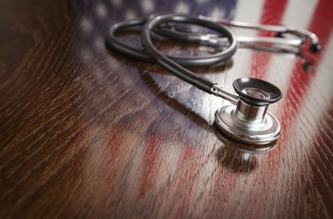 Medicaid Eligibility Information                Stethoscope with American Flag Reflection on Table