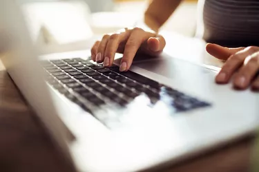 Young woman paying taxes from home