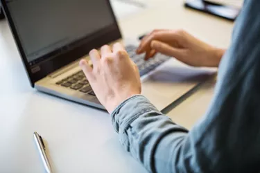 Close up of businesswoman working on laptop