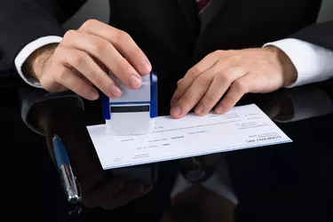 Businessman Stamping Cheque
