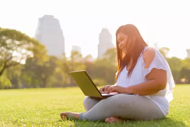 Beautiful Overweight Asian Woman Using Laptop Computer In Lumpini Park