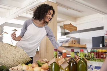 Woman Shopping For Organic Produce In Delicatessen