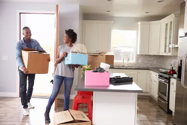 Young Couple Moving In To New Home Together